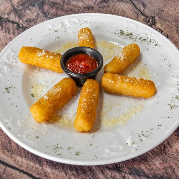 Six golden-brown mozzarella sticks with grated cheese and herbs, arranged around a cup of marinara sauce.